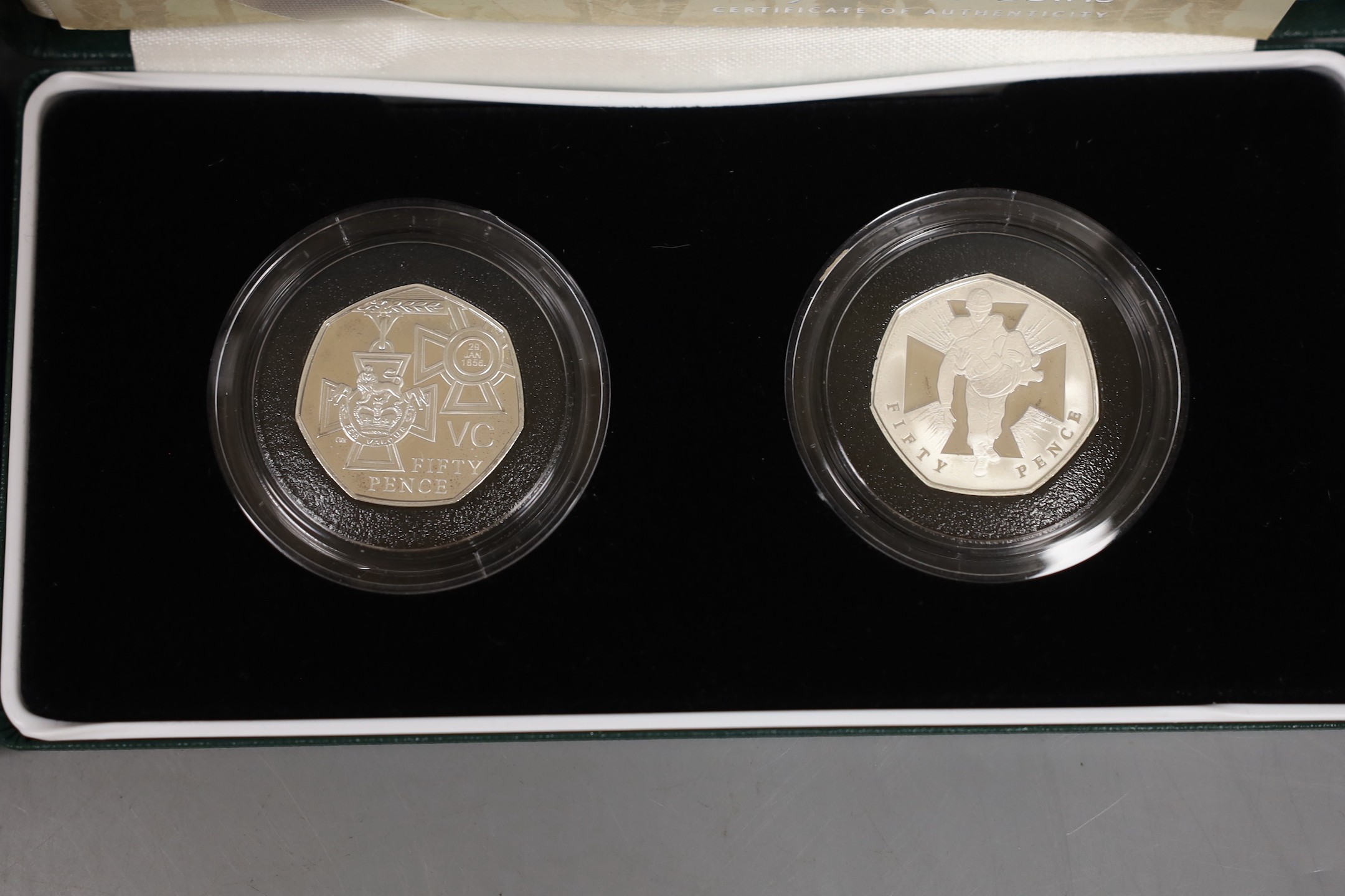 Cased Royal Mint UK silver proof coins – 2006 Victoria Cross two 50 pence, HM Queen silver jubilee two crown set and a 1994 three coin collection commemorating the 50th anniversary of the allied invasion of Europe (3 set